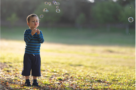 Cute little white boy blowing soap, a Person Photo by Barcelona_dreams