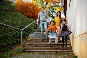 Sisters and parents jumping down the, a Person Photo by HalfPoint
