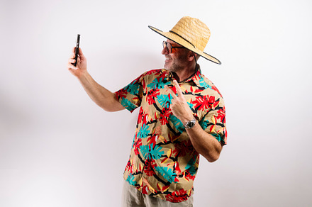 Middle-aged man taking a cheerful selfie on vacation