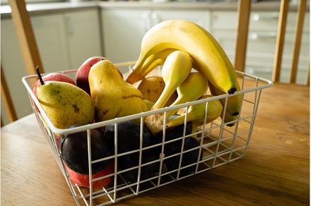 Basket with fresh fruits on table in, a Food & Drink Photo by oksix