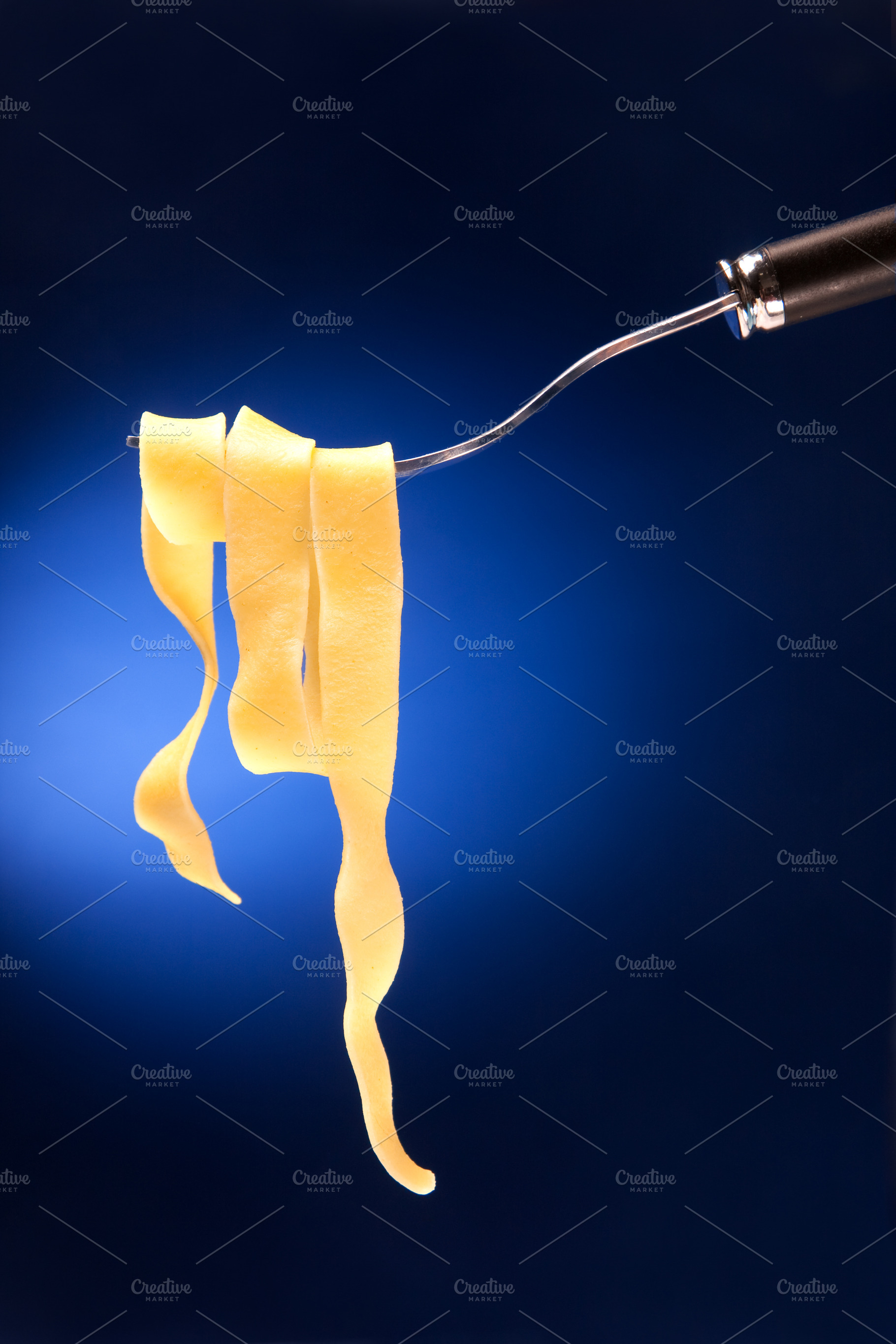 Fork with tagliatelle on a red background, a Food & Drink Photo by FoodStock