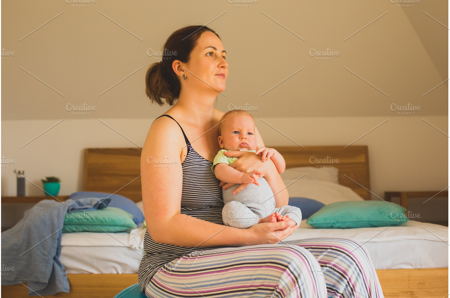 Mother holding and rocking baby, a Person Photo by oksix