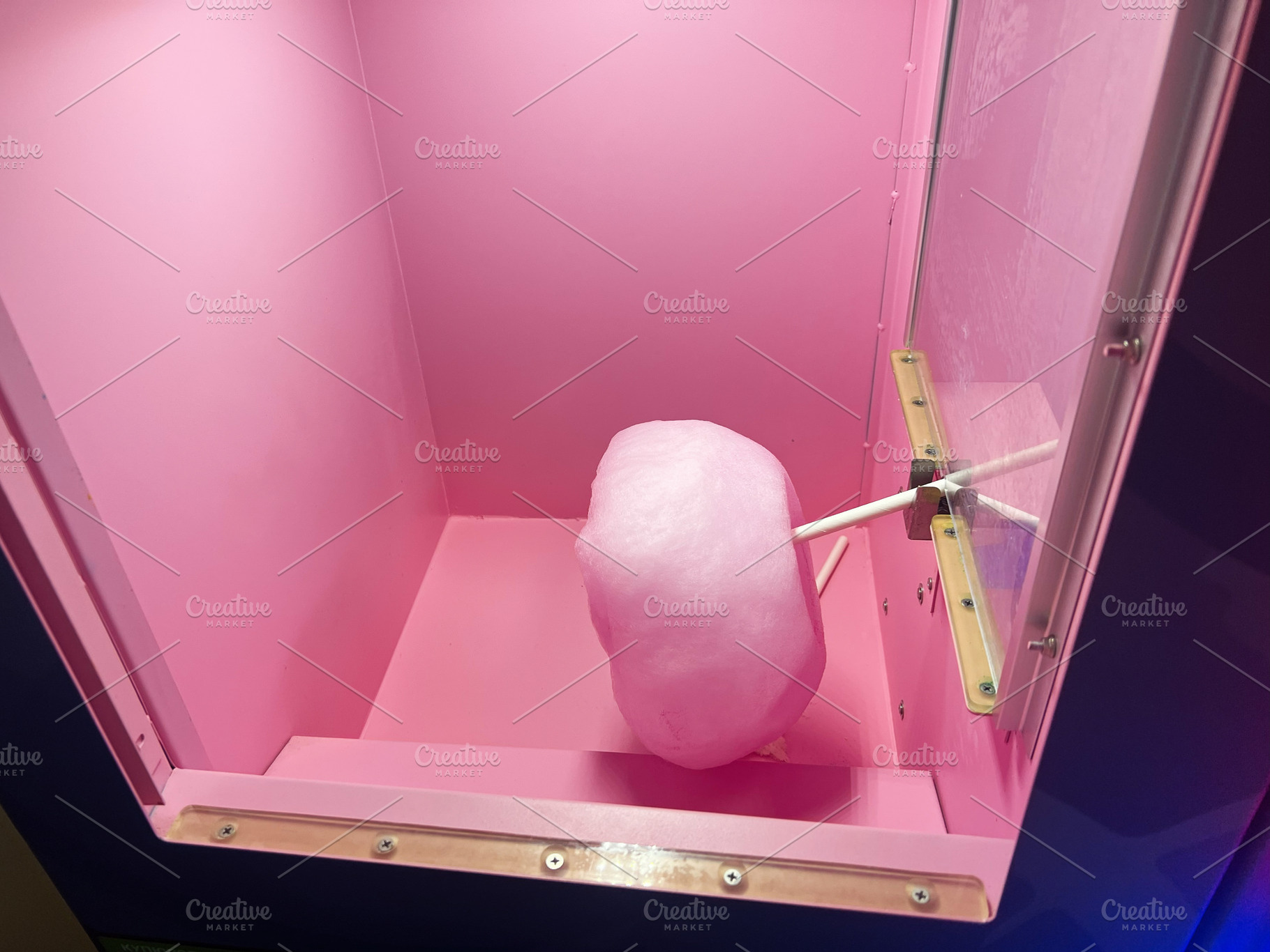 Pink cotton candy in a vending machine with a vibrant and colorful background, a Photo by AS photostudio