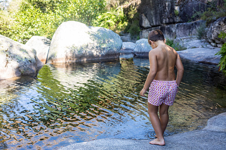 Little boy near of a river at summer