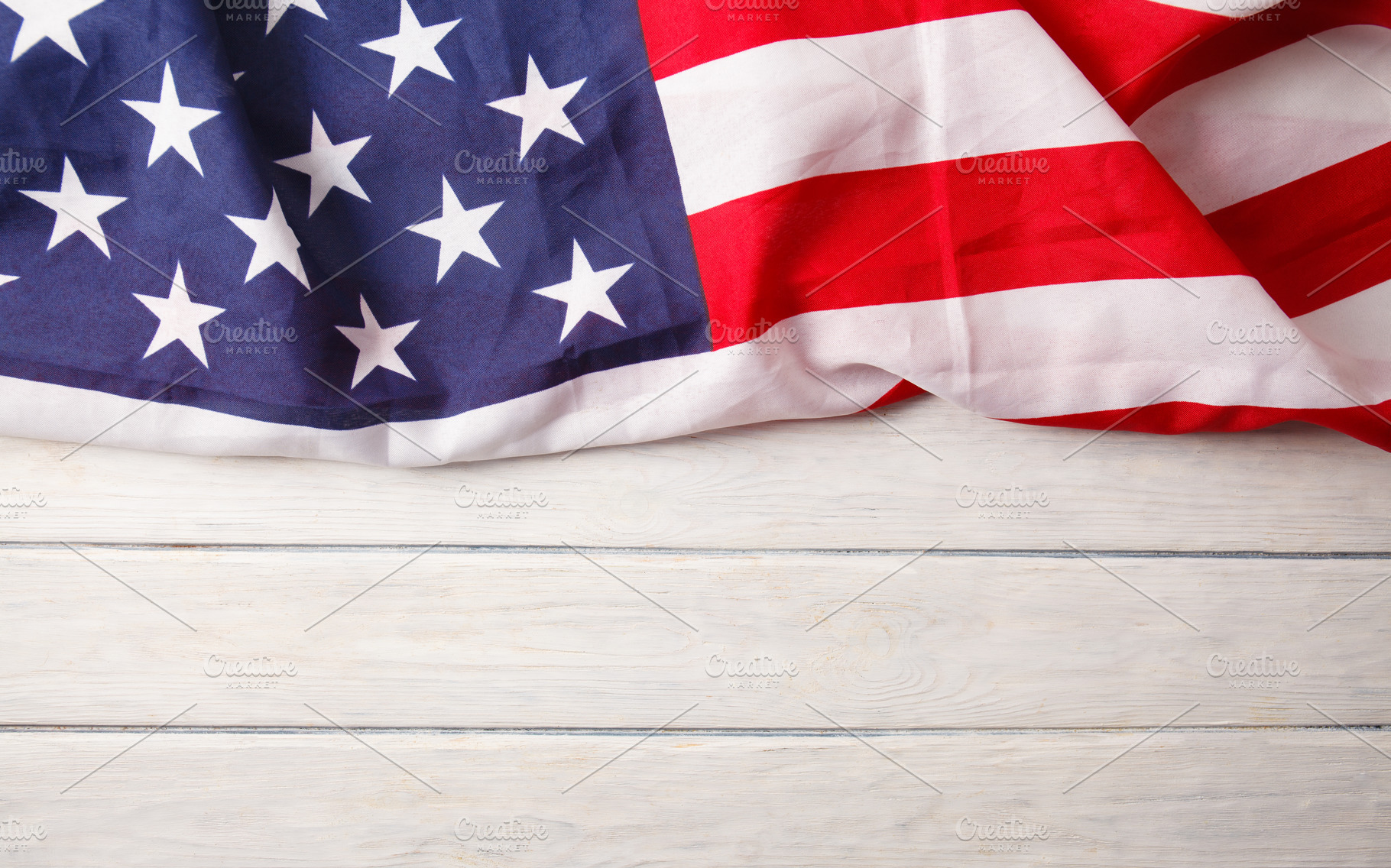 American flag close up on wood desk, a Background Photo by OleksandrRybitskyi