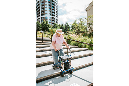 Elderly woman walking down the