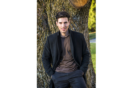 Handsome young man leaning against