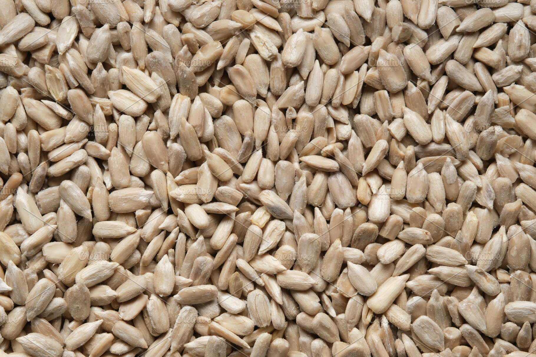 Shelled sunflower seeds background., a Food & Drink Photo by chamillewhite