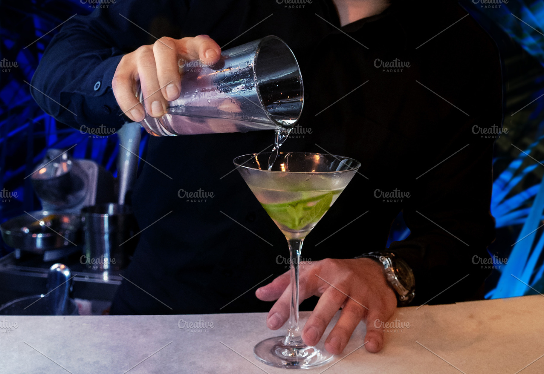 Barman serves cocktail with mint and, a Food & Drink Photo by Claudio Valdés