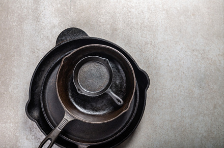 Cast iron pans or skillets on grey featuring iron cast, pan, and skillet, a Food & Drink Photo by MAnuta