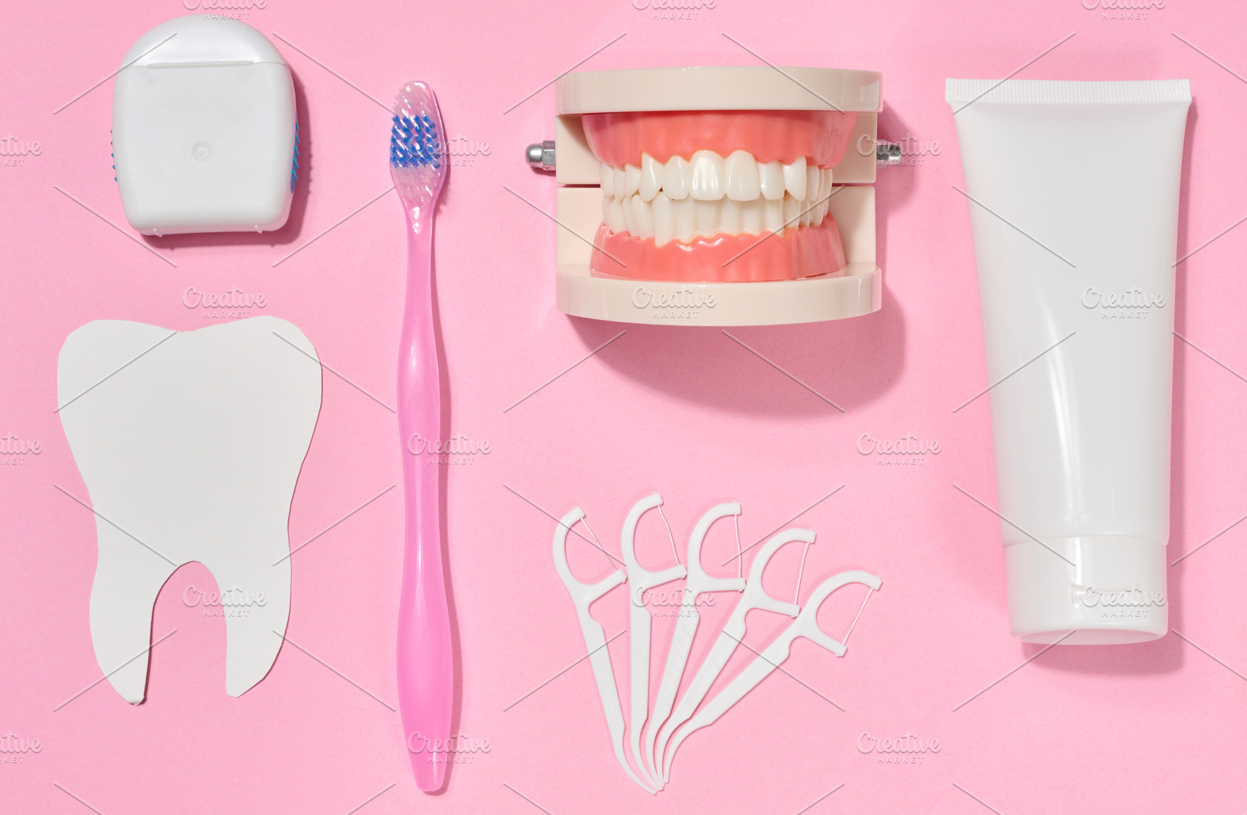 White tube of toothpaste, pink toothbrush, dental floss, plastic, a Health & Medical Photo by ndanko