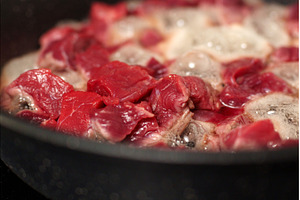 Chunks of raw beef are sizzling in a, a Food & Drink Photo by darksoul72