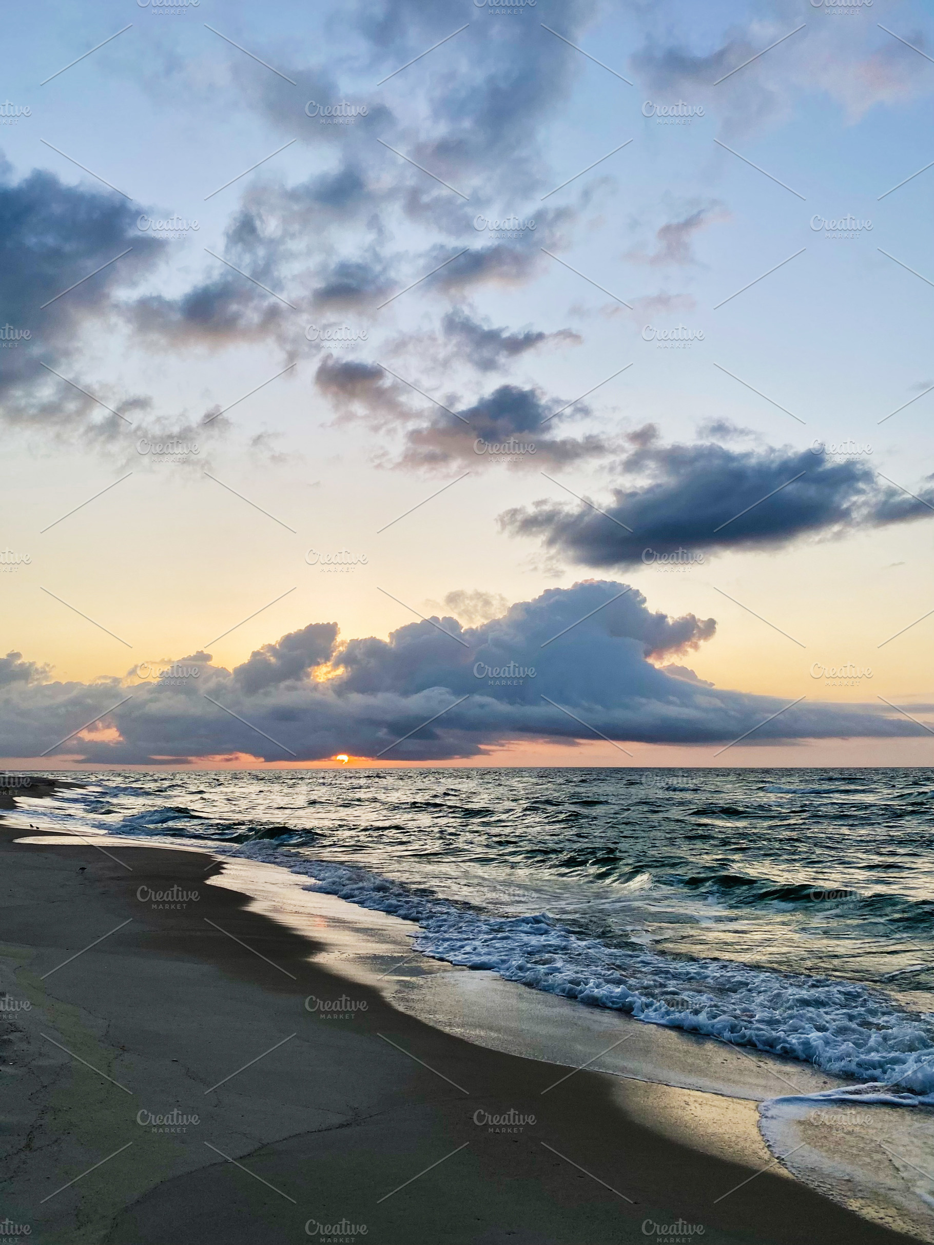Sunset over a calm Florida Pensacola beach with waves, clouds, and warm light o, a Nature Photo by AS photostudio