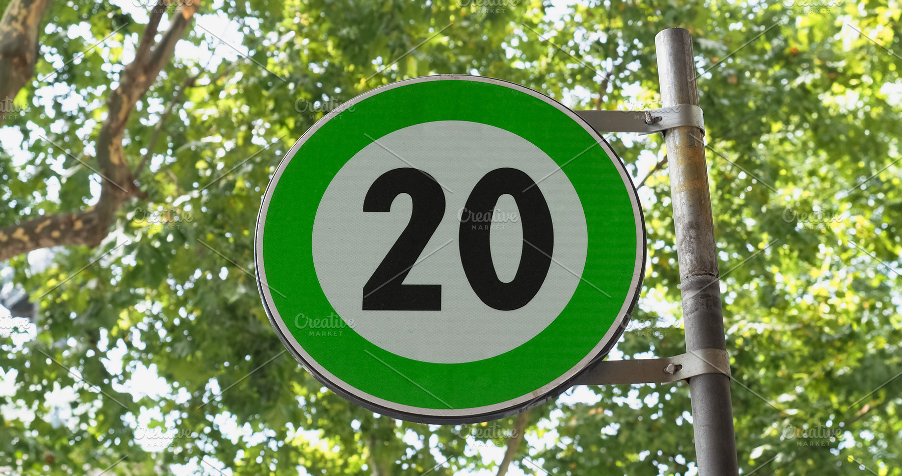 Green advisory speed limit sign, a Photo by WorldOfPhotos