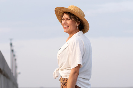 Smiling woman wearing straw hat walk