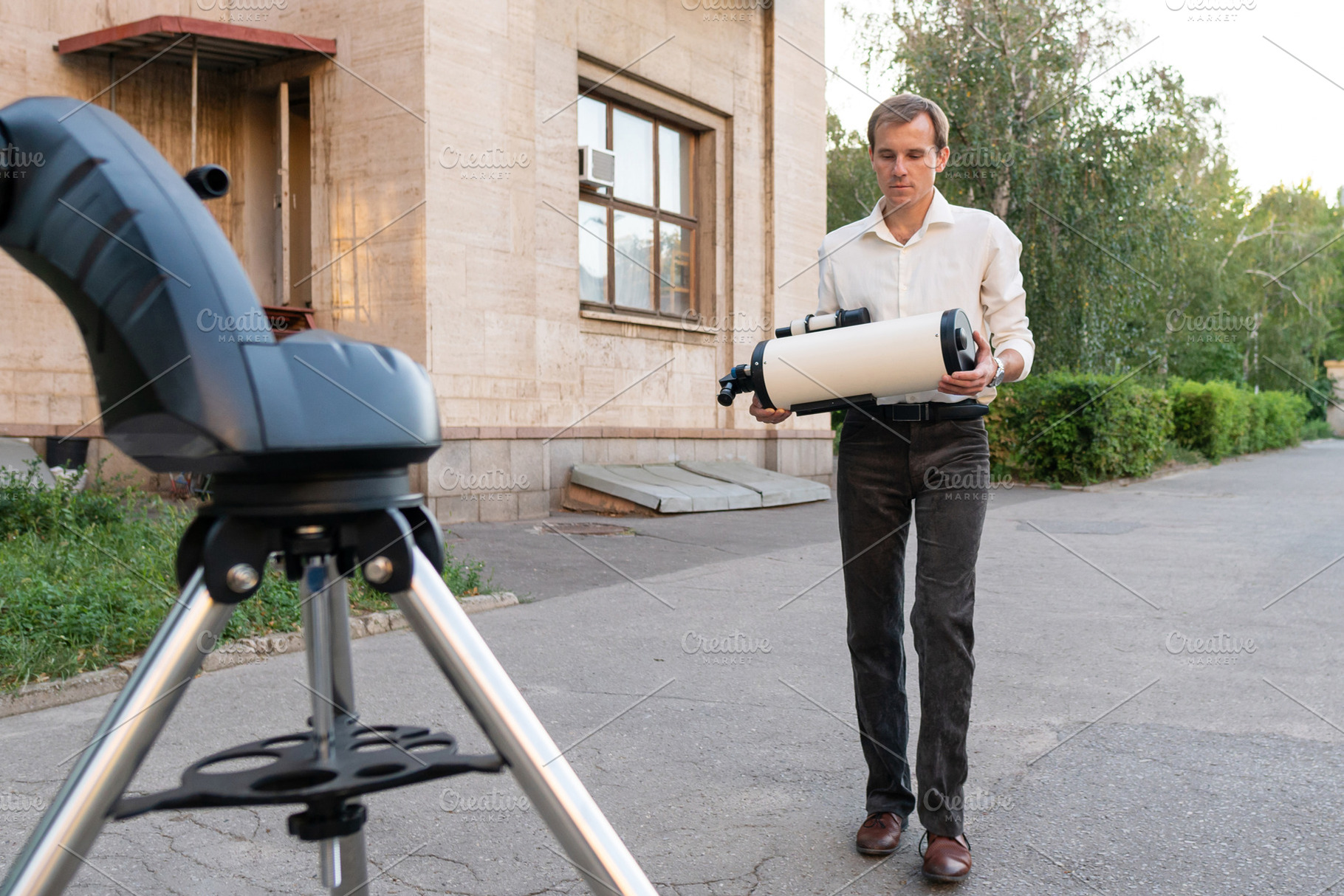 Astronomer carrying telescope tube, a School & Education Photo by Elena Vagengeim