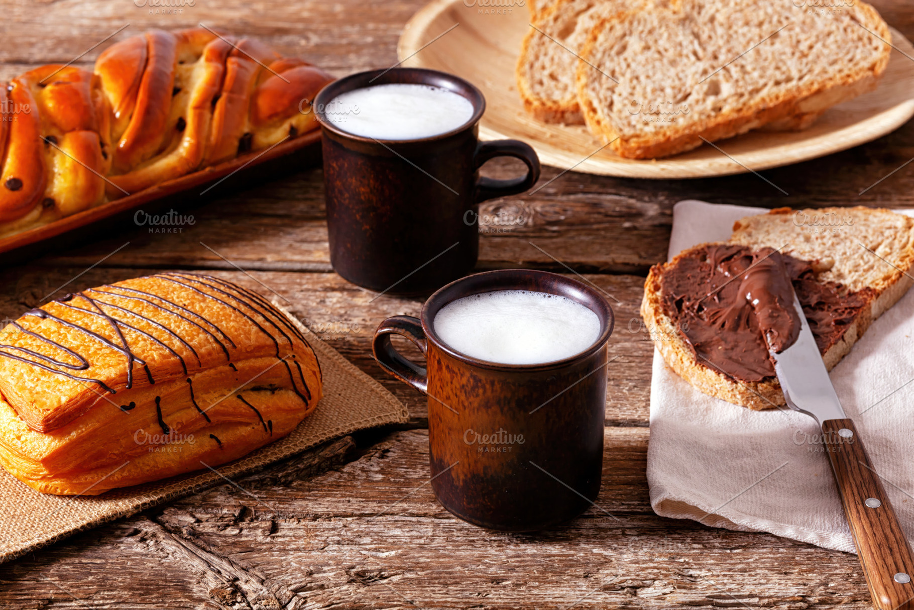 Delicious breakfast with whole wheat bread, chocolate cream, pastries and milk, a Food & Drink Photo by Antonio Gravante Market