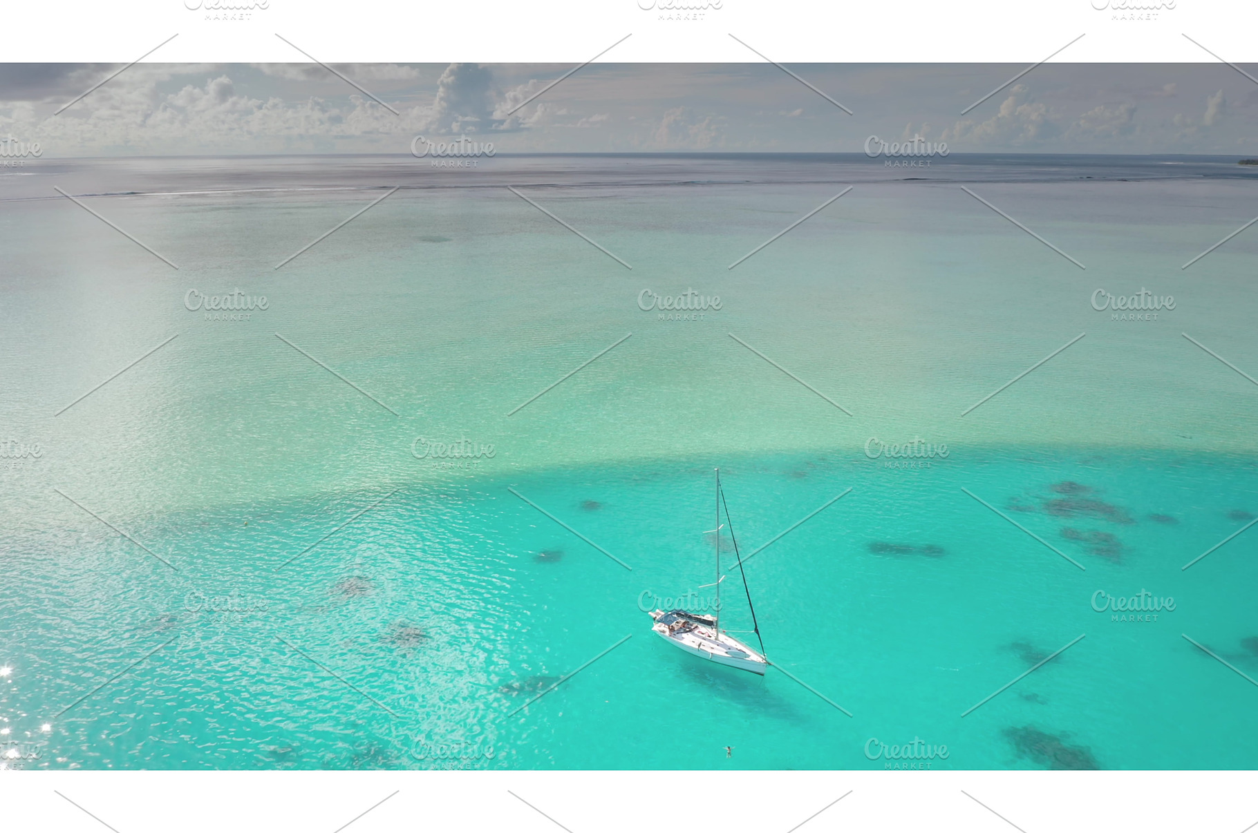 Sailboat anchored in clear turquoise, a Nature Photo by Goinyk