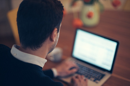 Man working at computer containing computer, man, and working