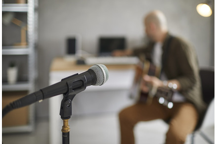 Microphone close up on blurred, a Person Photo by StudioRomantic