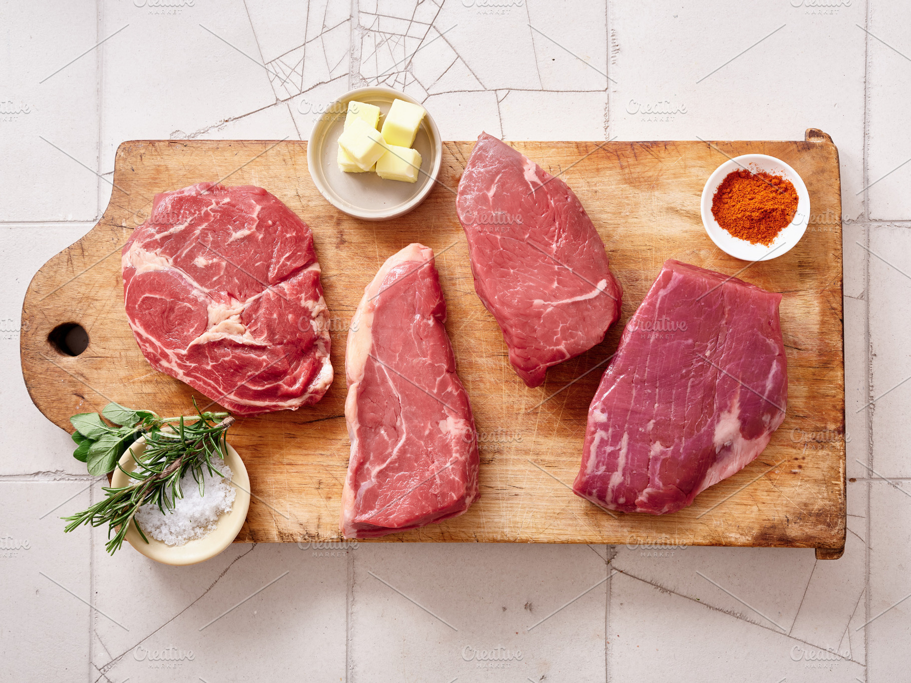 Different cuts of raw beef including rib-eye, roast beef, flank, and rump steak, a Food & Drink Photo by Asya Nurullina
