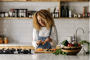 Woman preparing food in kitchen.