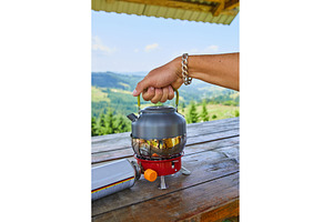 Preparing hot water outdoors with a, a Nature Photo by IlliaBondarPhotography