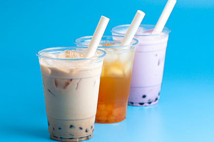 Three Different Types of Boba Tea on a Bright Blue Background