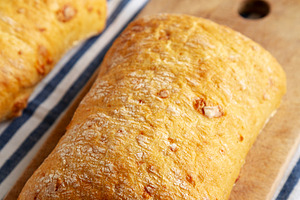 Homemade Cheese Ciabatta Bread on a Wooden Board, side view.