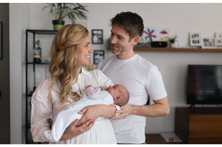 Smiling mother and father holding, a Person Photo by HalfPoint