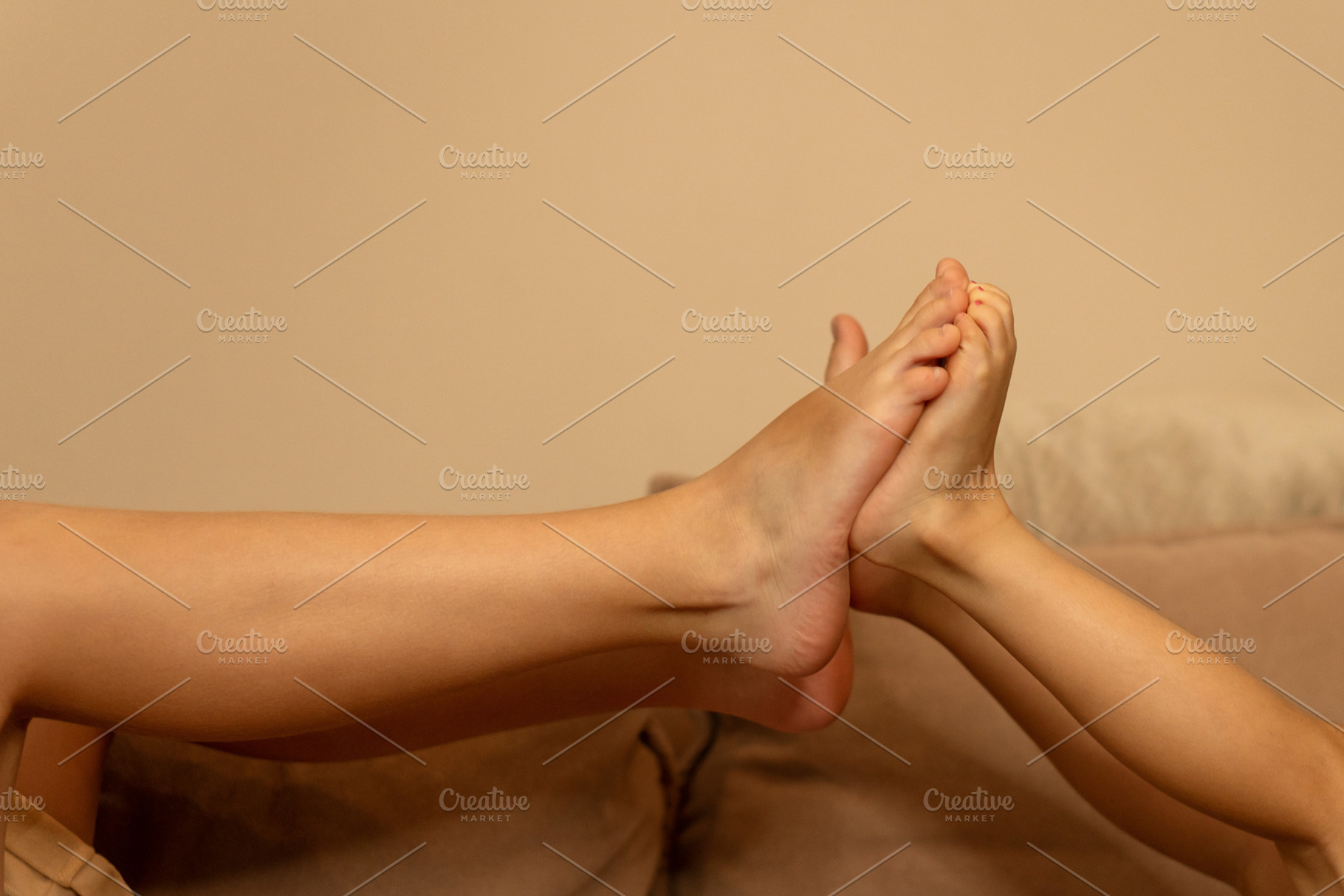 Children press feet together in play, a Background Photo by Elena Vagengeim