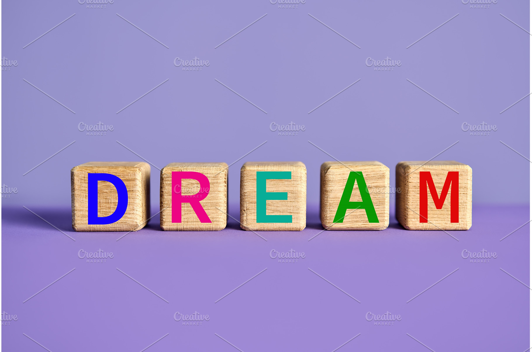 The word DREAM on wooden blocks over, a School & Education Photo by Gladkov photography