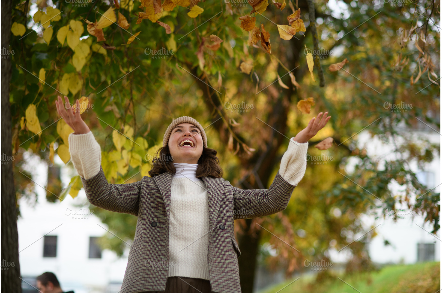 Happy woman throwing fallen autumn, a Beauty & Fashion Photo by HalfPoint