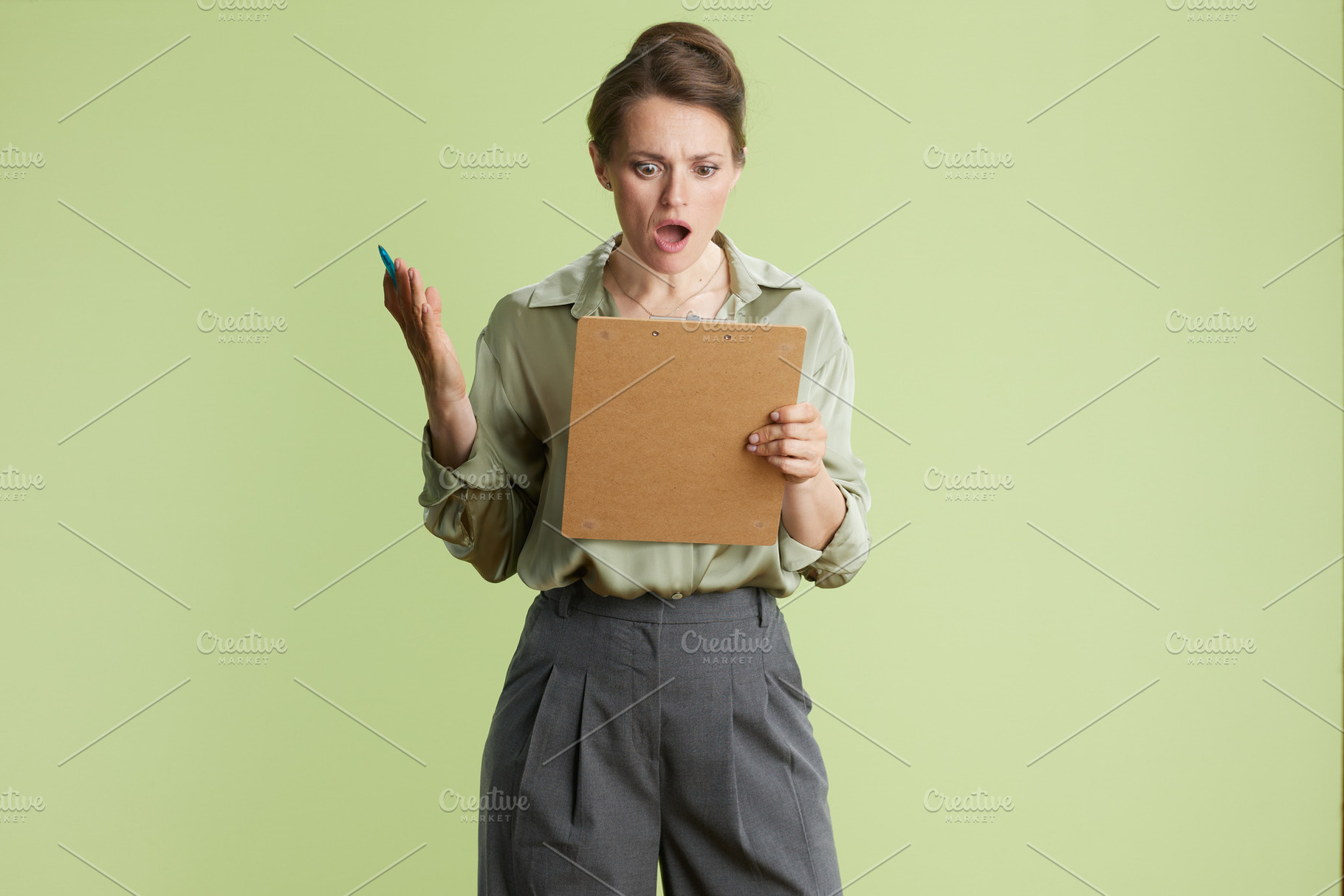 Surprised woman with clipboard, a Person Photo by Alliance Images