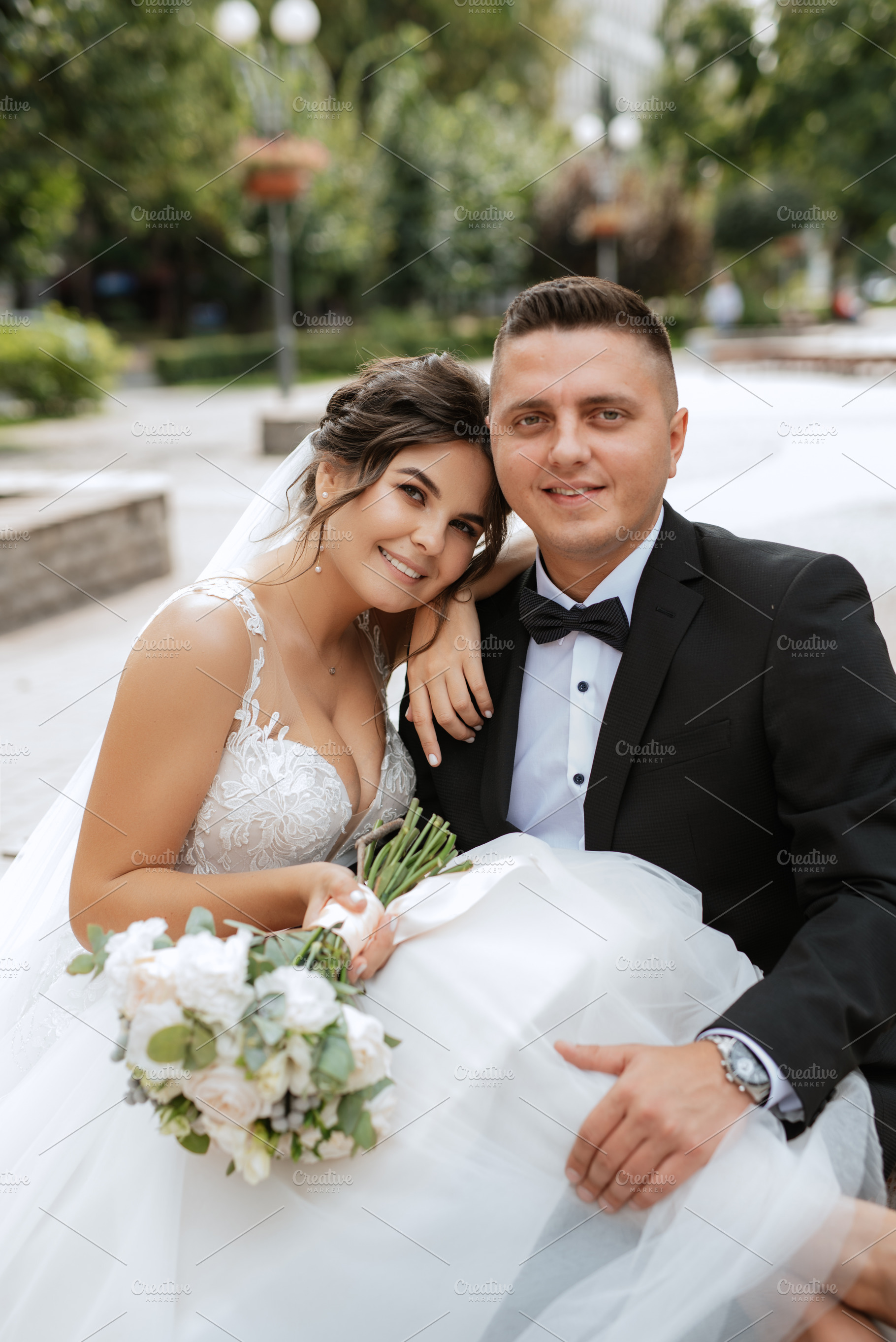 the groom in a brown suit and the bride in a white dress, a Person Photo by Weddings, People, Travel