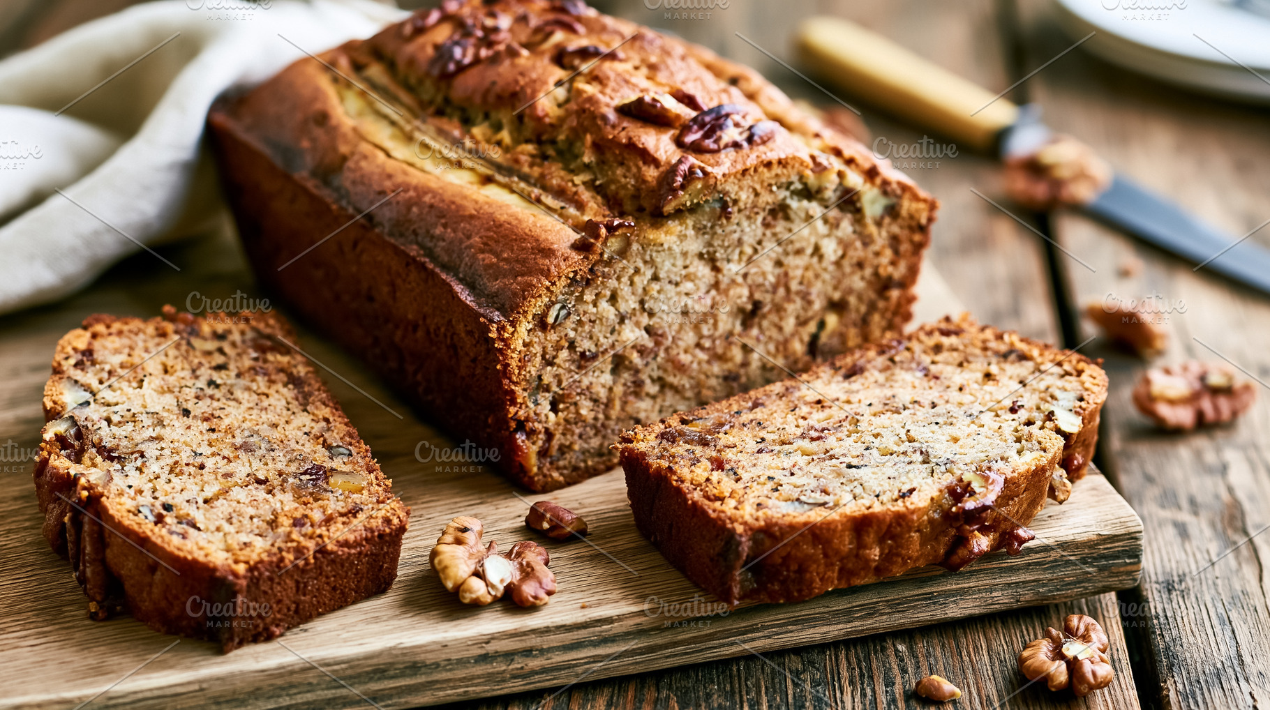 Homemade banana bread loaf with walnuts, sliced on a rustic wooden board, ready, a Photo by Studio ANNA