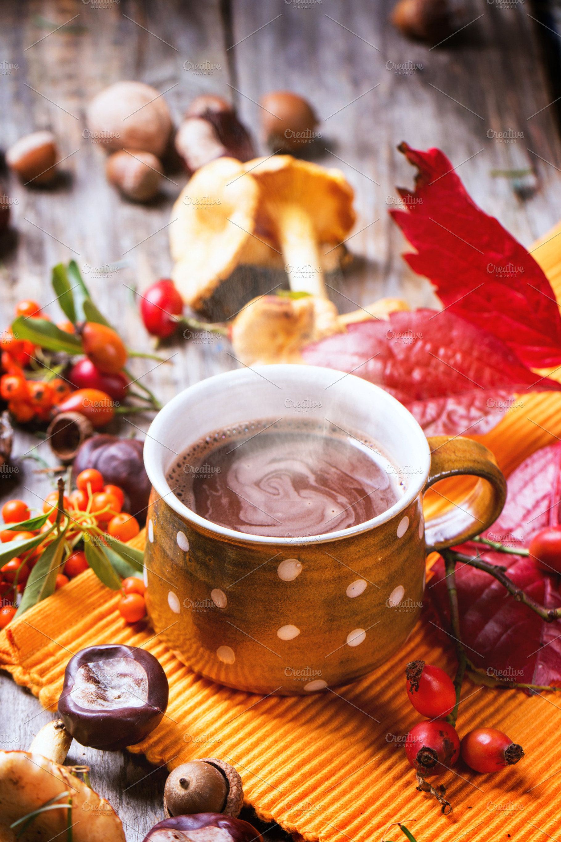 Ceramic cup of hot chocolate served with mushrooms and nuts over wooden table