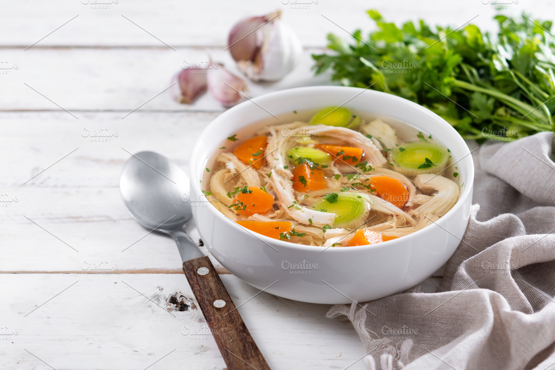 Homemade chicken soup in white bowl with carrots and celery, a Food & Drink Photo by etorres69