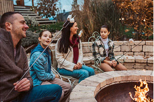 Family roasting marshmallows over, a Food & Drink Photo by HalfPoint