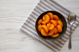 Organic Canned Mandarin Oranges in a Bowl, top view. Copy space., a Food & Drink Photo by LiudmylaChuhunova