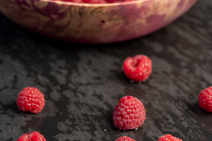 the collected amount of ripe raspberries is red close up, side view, a Photo by rsoollAI
