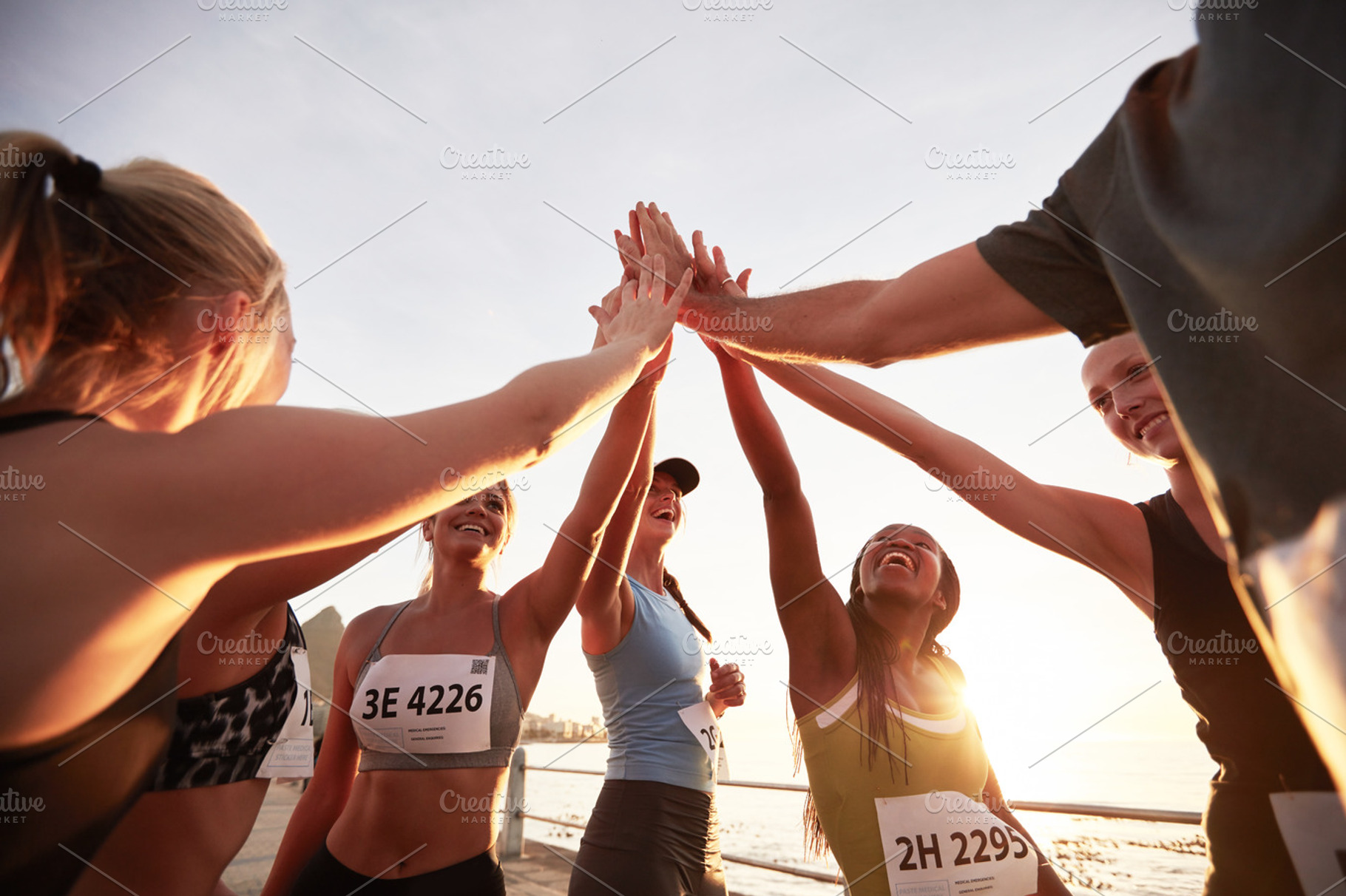 Group of athletes high fiving, a Sports & Recreation Photo by Jacob Lund