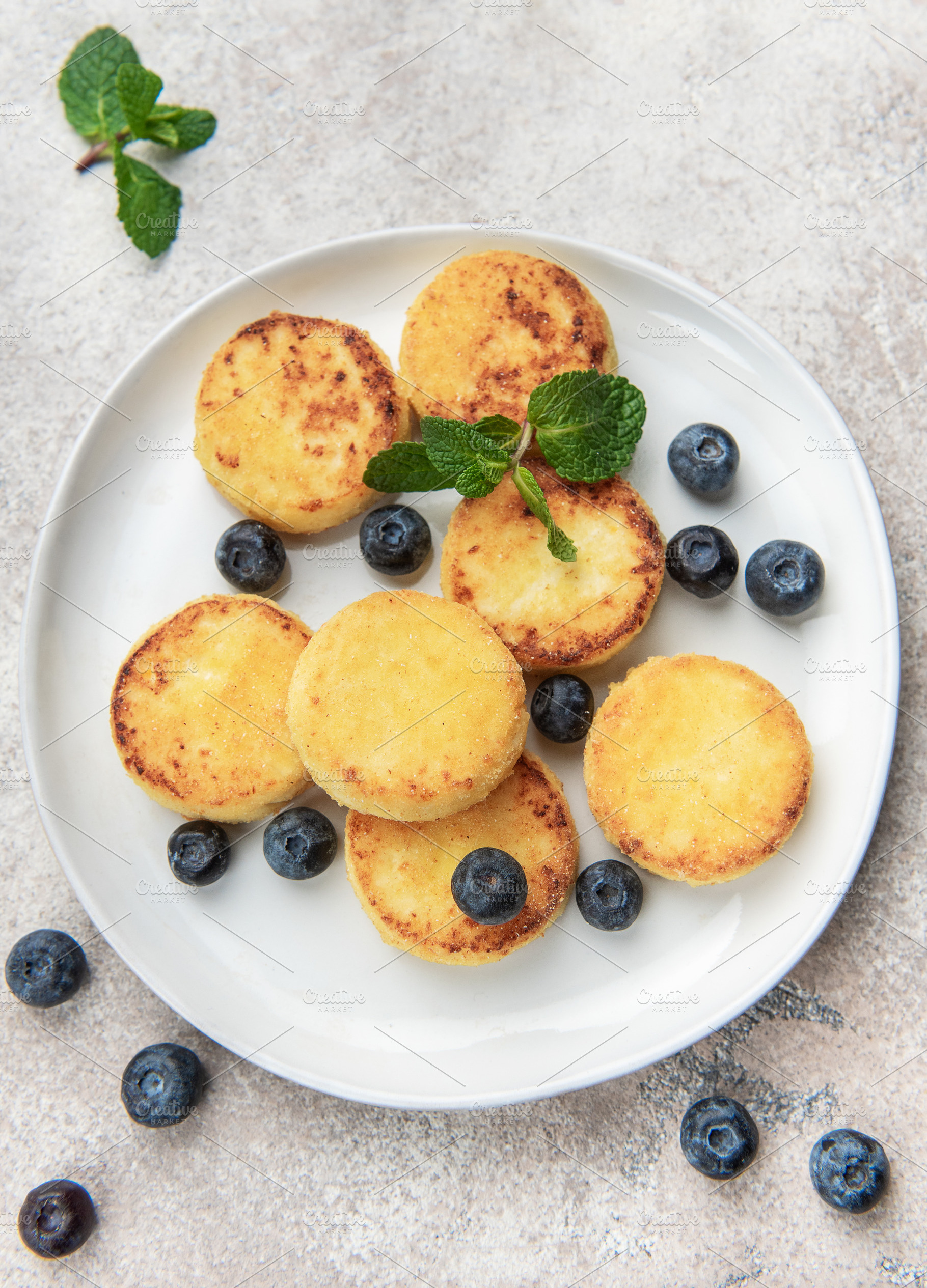 Homemade syrniki cottage cheese pancakes with blueberries and mi, a Food & Drink Photo by Olena Rudo
