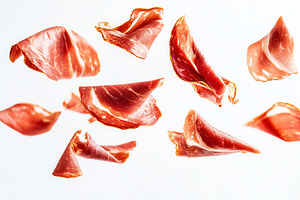 Floating slices of prosciutto ham, a Photo by Pavel_design