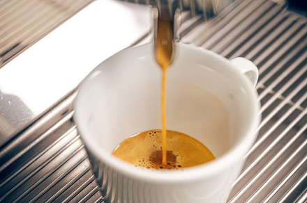 Professional coffee machine pouring espresso coffee