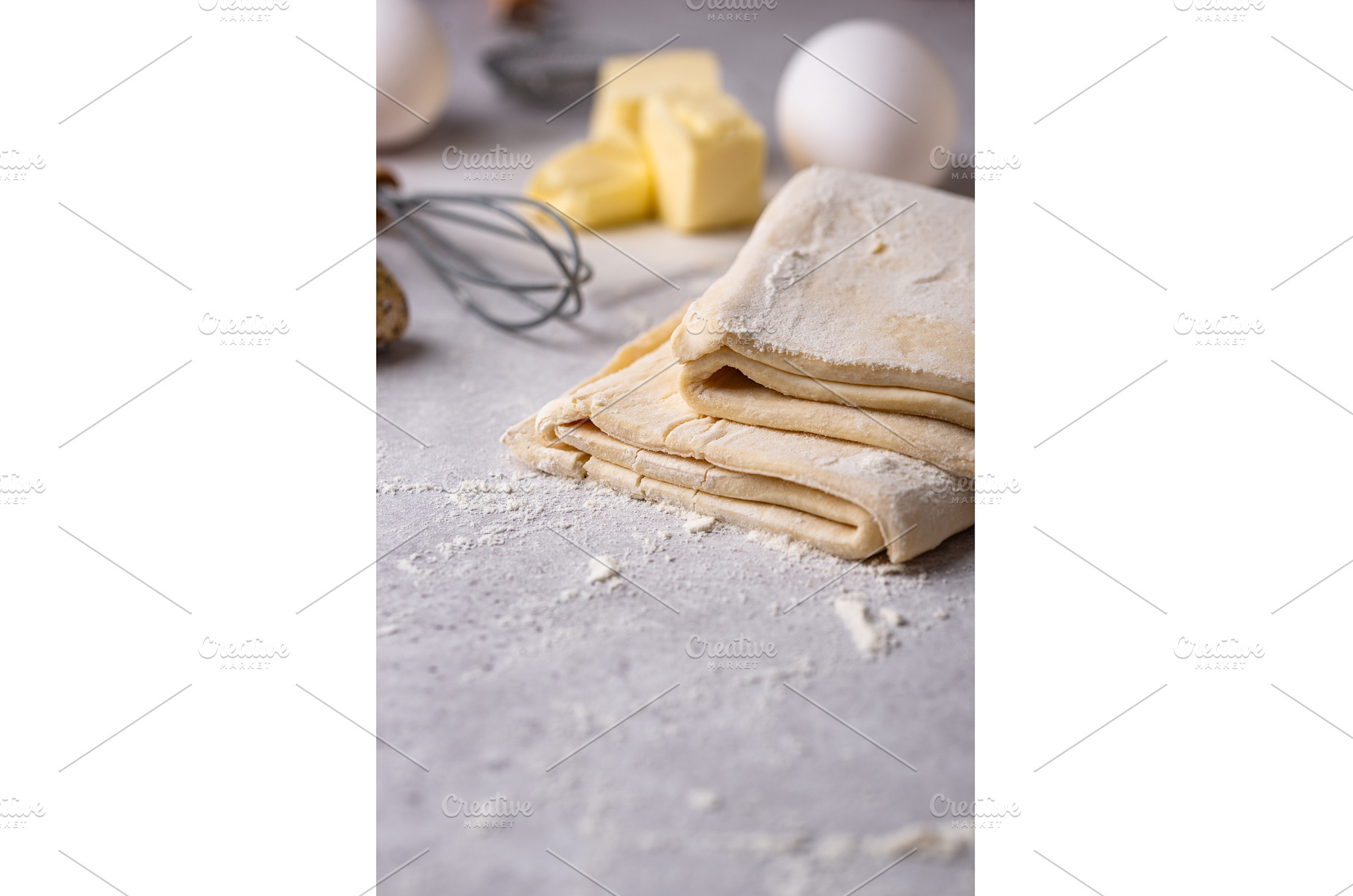 Raw puff pastry dough with baking, a Food & Drink Photo by Yulia Furman