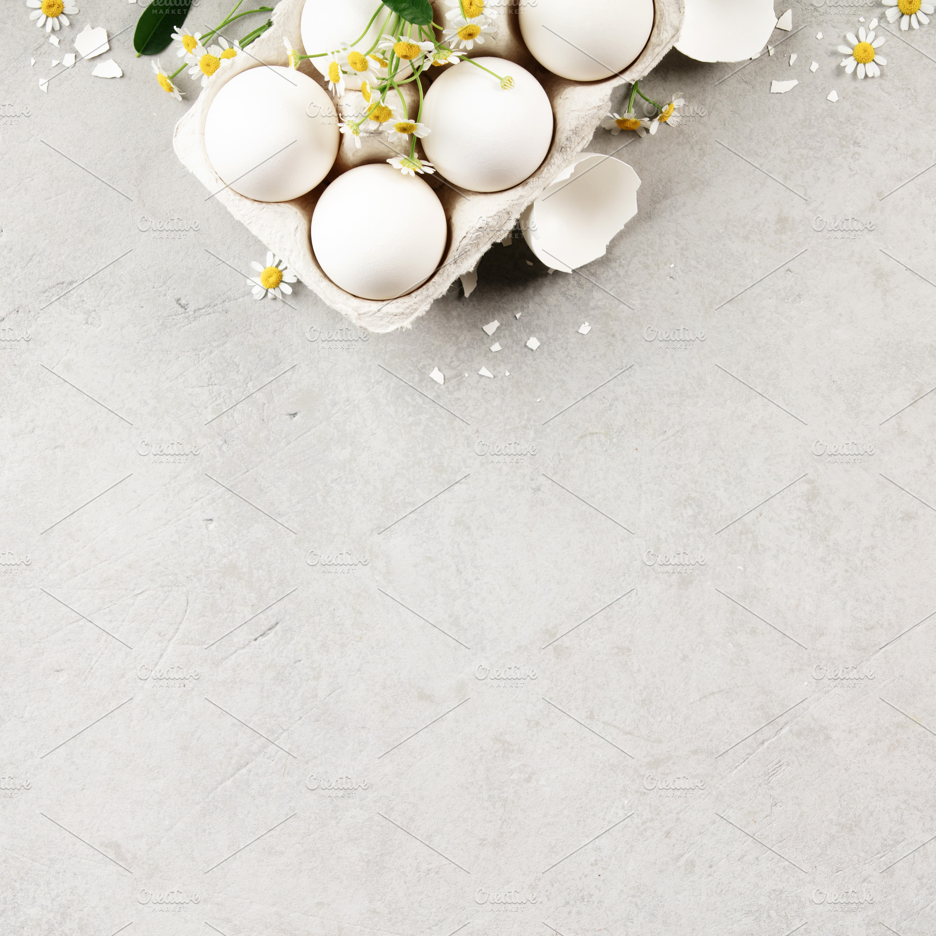 White Eggs in Carton with Chamomile Flowers on Light Background, a Holiday Photo by Natalia Klenova's Shop