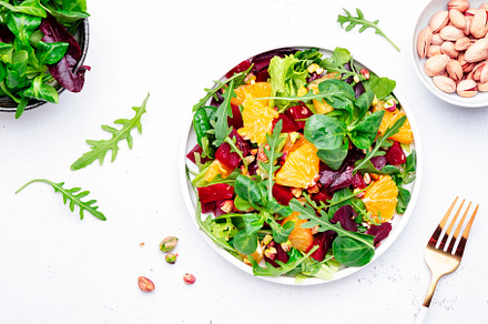 Beet and orange healthy salad with arugula, lamb lettuce, mini c, a Food & Drink Photo by 5PH