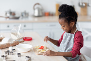 Adorable little black girl making cookies, side view, a Photo by Prostock-Studio (Thumbnail 1 of 2)
