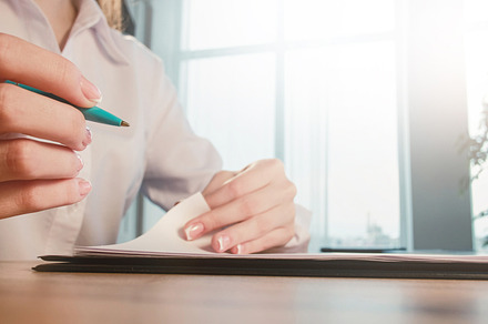 Business paperwork woman pen hand reading document, a Business Photo by Photo Drive Studio